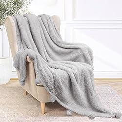 gray throw blanket with pom poms
